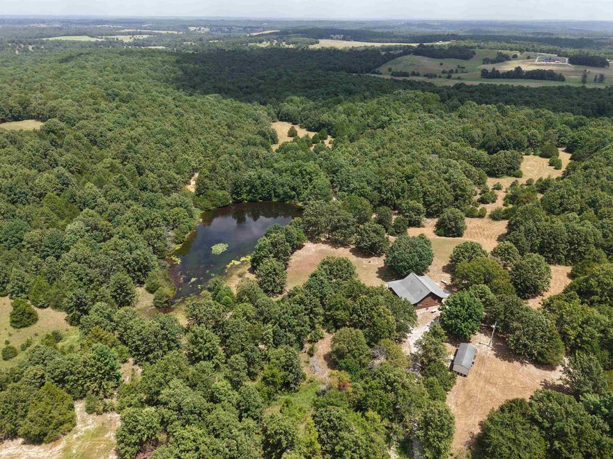 Escape to the Ozarks with this stunning custom log home for sale in Arkansas, perfectly situated on 55 +/- unrestricted acres of private, recreational land.  This 3-bedroom, 2-bathroom home features a spacious loft, custom home design, and an unfinished basement with expansion potential- spanning approximately 2,476 total square feet of living space.  The property includes a charming wrap-around porch overlooking a beautifully landscaped yard. There are two stocked ponds and an established trail system that offers endless opportunities for fishing, hiking, ATV riding, and exploring the outdoors.  Located on a private road, this secluded property is a haven for wildlife—ideal for hunting, nature watching, or simply enjoying the rural scenery.  Whether you're searching for a private homestead, a hunting retreat, or a country getaway home, this property offers it all- listed for only $359,900! Don’t miss your chance to own this beautiful piece of Arkansas real estate!