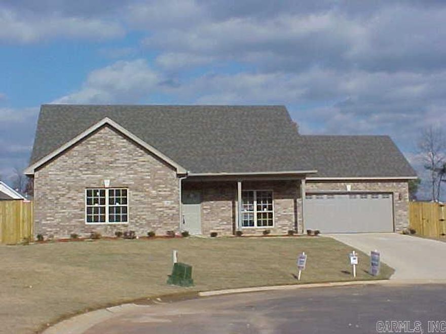 Wonderful like new 3 bed 2 bath 1,570 sq ft home on cul-de-sac w/ pvc fence. Hand-scraped wood floors, like new paint, wood cabinets, granite tile countertop in spacious kitchen, stylish updated lighting & SS appliances. Great room with fp, open dining and great for entertaining. Bedrooms spacious with tons of closet space and master suite oversized. Bryant Schools and move-in ready. A must see.