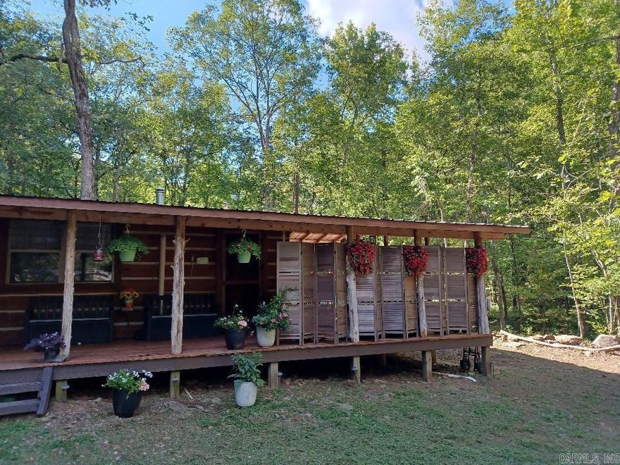 Creeks, several creeks on the property, caves, ATV trail, trickling waterfalls, small swimming hole. Overlooking a creek & mountainside from the covered porch, Backyard orchard w variety of fruit trees (5 yrs. old), Berry bushes, grapevines, garden boxes, 2 picnic tables. 1Bdrm cabin w NEW flooring, septic system w grinder pump, concrete countertop, built-in pop-up table. Well water w hand pump option & insulated well-house, root cellar w metal walls w food storage shelves built in. Propane tank for gas stove & water heater. Laundry room w storage is separate behind the cabin. Wi-Fi, NEW electric power & fiber optic lines were recently installed underground. Firewood stacked ready to burn in the wood stove for cozy winter nights at home. 2 newly added 20'x8’ Shipping containers, that can become tiny homes, storage or offices, both Framed & insulated, w electricity. shelving, mini fridge, counters, a/c, heater units, LVP flooring, & composting toilets. Windows, Door w built in blinds, and deck. Could be hooked to water/shower/sink if units are moved, plumbing hookups, shower, & sink, are already installed but unused. 2 Attached gasoline tanks that can also convey & much more!