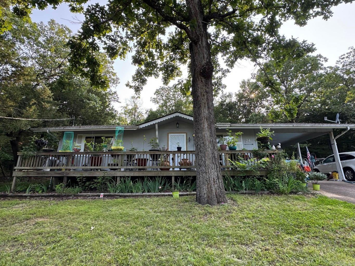 Secluded but close to amenities. This 2 Bed 1 Bath home has no visible neighbors and lots of wildlife to sit on the deck and enjoy. Home features open floor plan with vaulted ceilings, engineered hardwood throughout, dedicated laundry, double pane windows, a full length front deck, and a one-car carport. Recents updates included are the new roof and septic in 22. Lots of flowers and trees in the yard along with a gazebo to enjoy the outdoors!