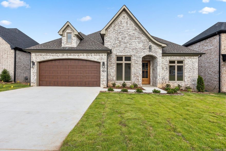 Welcome home to 303 Copper Drive!   This meticulously designed home offers an unparalleled living experience catering to your every need. Surrounded by lush landscaping and mature trees, the Copper Run community provides a secluded atmosphere while being just moments away from your favorite shopping and dining spots in West Little Rock. This single-level home features 4 bedrooms, 2 full bathrooms, and one 1/2 bath. Enjoy the natural views from your spacious living room with large windows or relax on your covered back patio that features a cozy outdoor fireplace. The primary suite offers a private and luxurious oasis with a soaking tub, oversized walk-in shower, and a custom closet connected to the laundry room for convenience. The chef's kitchen boasts quartz counters, designer fixtures, energy efficient appliances and a layout that is perfect for entertaining.   Combining designer curated style and functionality, this home is set to be completed by September 2024.