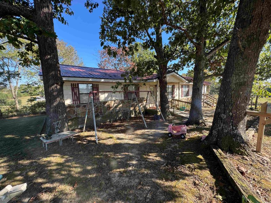 Sitting in the country on 2.3 acres , this home is a fixer upper.  Would be good for full time or just to get away. The property also has an extra septic system and water meter connection so it would be good for a tiny house, mobile or another full size home. Would make a good rental and can add another. 15 minutes to Hill Creek Marina and Boat launch. Drive by and give us a call today.