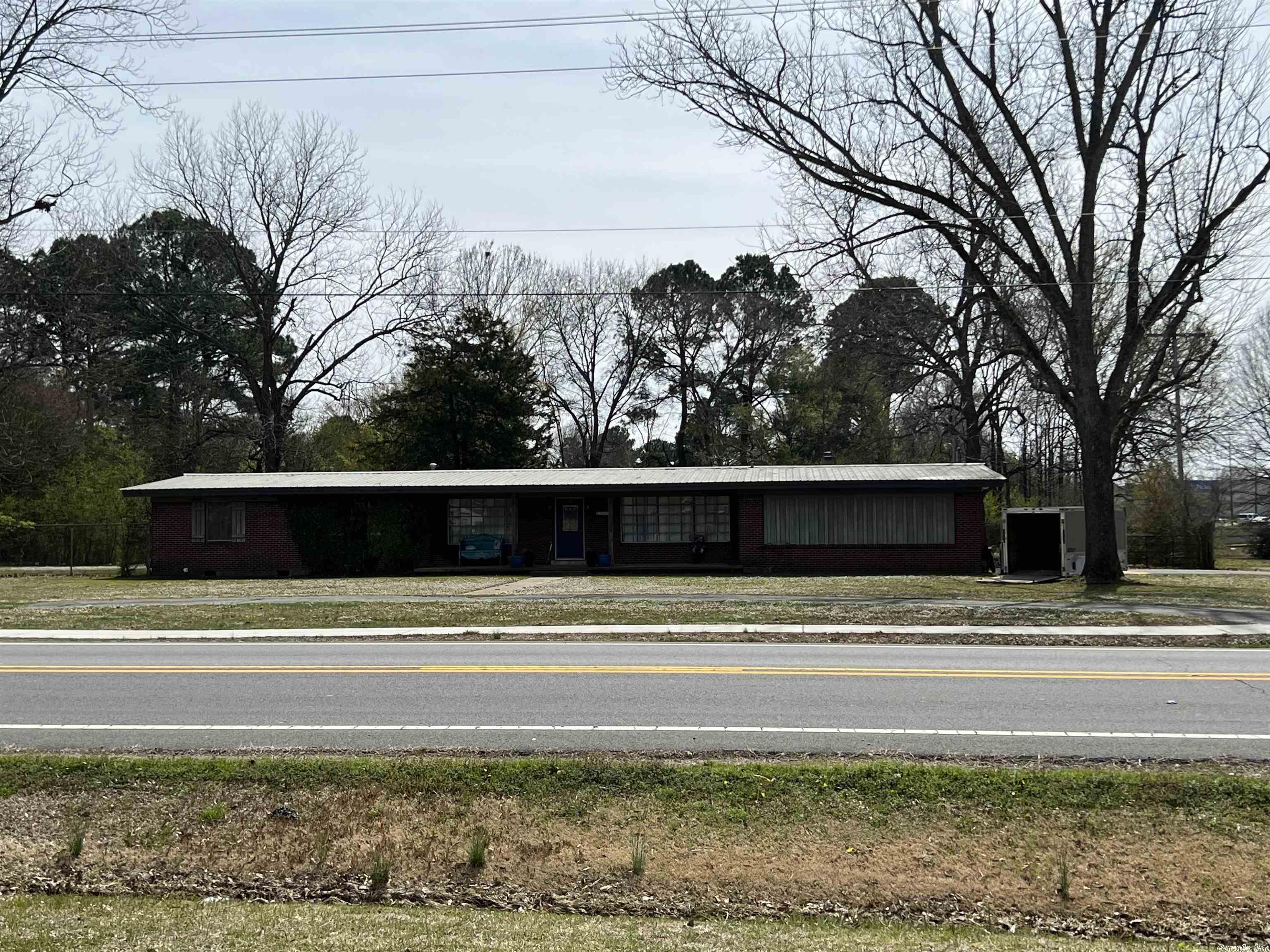 HIGH TRAFFIC COUNT! Close proximity of Wal-Mart Super Center & other fast growing businesses. Recently zones commercial. Presently 1708 sq.ft. home on property. Less than 1/2 miles from interstate. Additional acreage available, SEE MLS#23008178