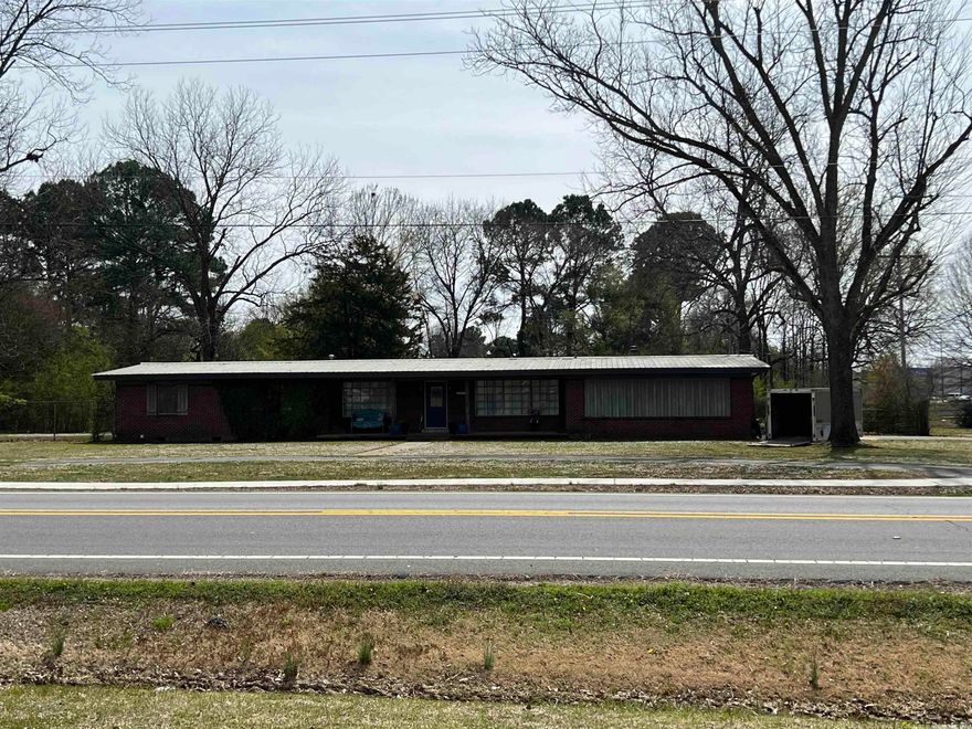 HIGH TRAFFIC COUNT! Close proximity of Wal-Mart Super Center & other fast growing businesses. Recently zones commercial. Presently 1708 sq.ft. home on  property. Less than 1/2 miles from interstate. Additional acreage available, SEE MLS#23008178