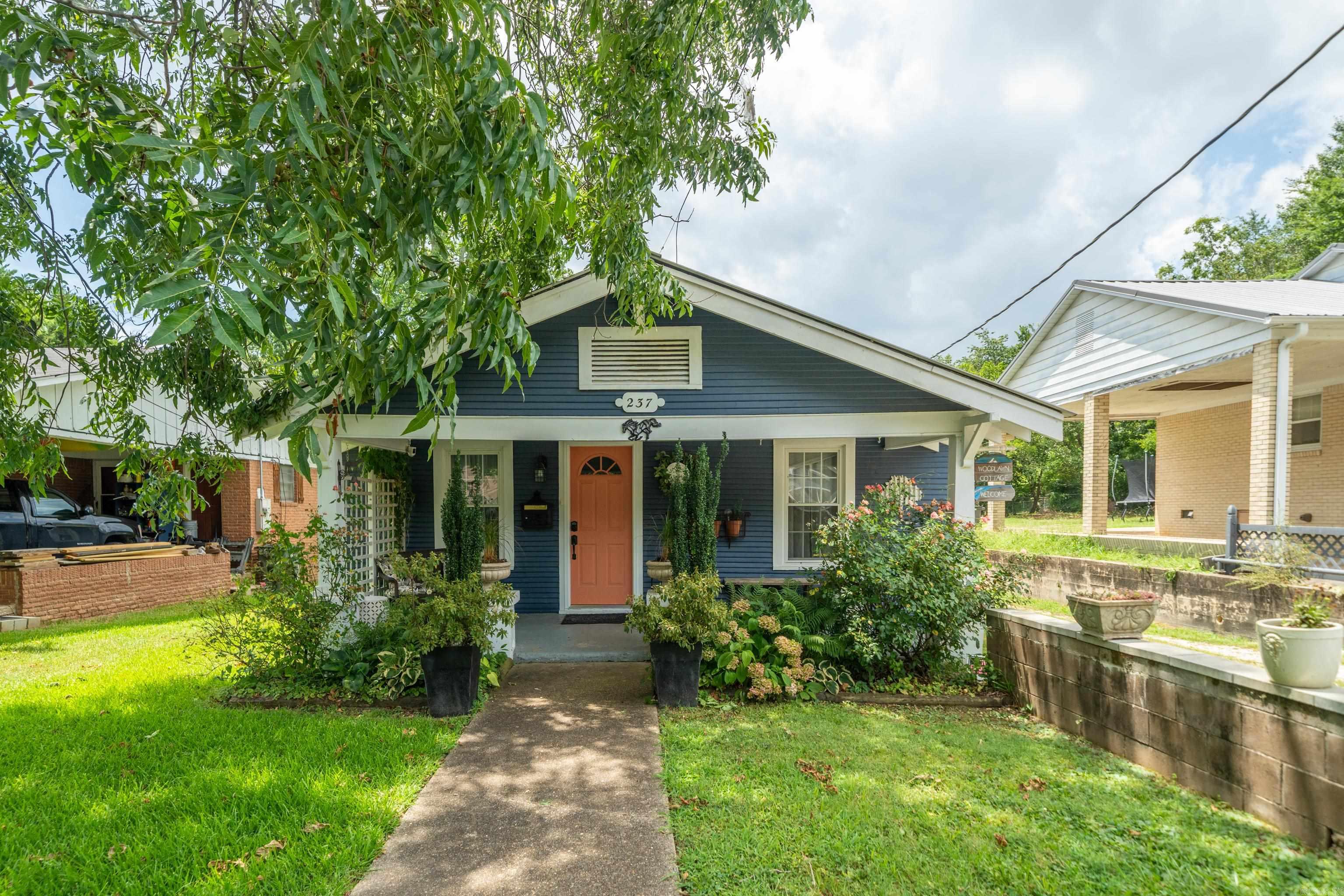 INVESTORS - STR OPPORTUNITY AWAITS! Come see this Unique Cottage Impeccably Decorated to the Max with a Designer's Special Touch! This Charming 2-bedroom, 1-bath, is Selling Fully Furnished with Two Separate Living Rooms, Completely Renovated with Beautiful Hardwood Floors, and LVP, Exposed Brick Chimney in Kitchen and Bedroom, New Appliances, White Quartz Countertops, a Well-Stocked Kitchen, Full Pantry, Coffee Station and a Kitchen Island. New Sump Pump, Updated Electrical Throughout, New Hot Water Heater. Enjoy the Beautiful Flower Garden and Oversized Private Backyard in an Incredibly Quiet Neighborhood just Walking Distance to Oaklawn and a 2-minute drive to Downtown Bathhouse Row and Lake Hamilton, 10 minutes to Magic Springs and 5 miles to Northwood Trails. We are proud to call ourselves "The Woodlawn Cottage" and have an Active Transferrable License for Short-Term Rental; an Ideal Turn-key Investment Opportunity. This Remodel is a Testament to the Owner's Love and is Evident in Every Detail and Decision. A Home Away From Home - This Location Can't Be Beat! Call for Your Appointment Today! NOTE: There is a discrepancy in square footage, 1100 vs 1016, feel free