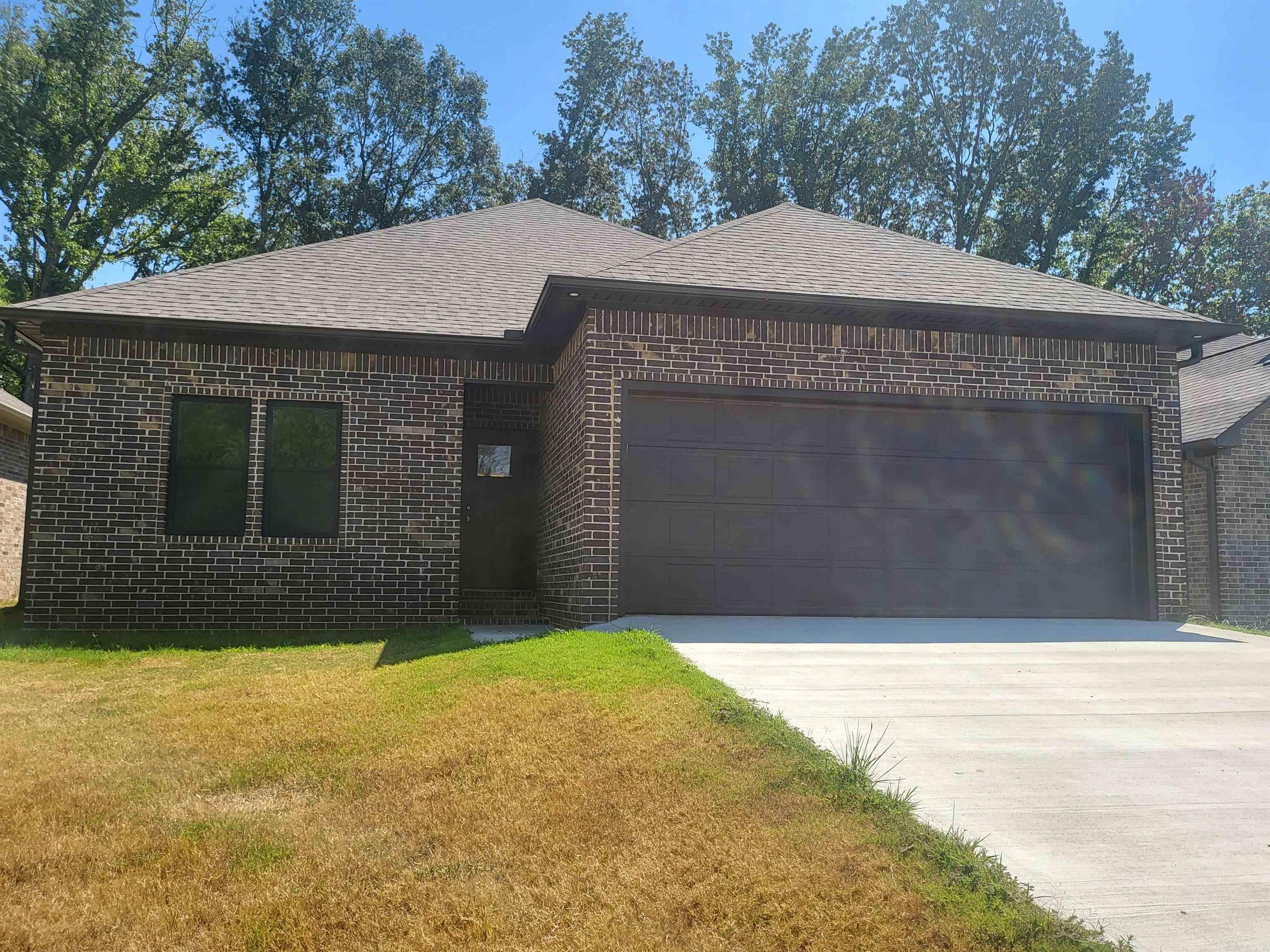 Discover this stunning new construction home at 933 N Jeff Davis Ave in Jacksonville, AR! Ideally located between the Little Rock Air Force Base and convenient interstate access, this home offers modern design and upscale finishes in one of the best locations around. The spacious living room showcases a custom dark-stained wood vaulted ceiling and stone fireplace, creating a warm and inviting focal point. The kitchen features a large island, all-wood cabinets, solid surface countertops, custom tile backsplash, designer lighting, and a generous dining area. With 9-ft ceilings, abundant natural light, and a primary suite boasting a luxurious walk-in tiled shower, this home combines comfort and craftsmanship. Schedule your private showing today!