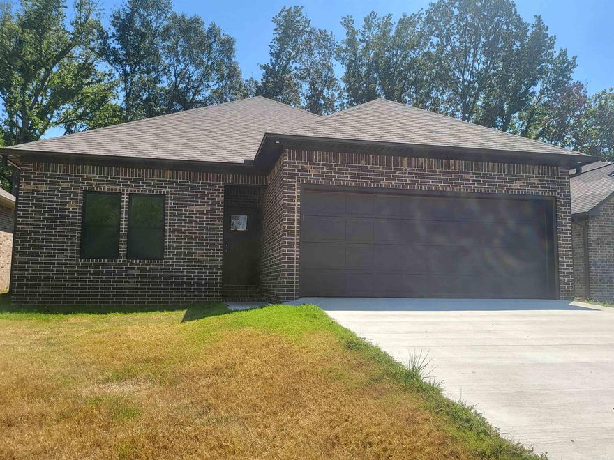 Discover this stunning new construction home at 933 N Jeff Davis Ave in Jacksonville, AR! Ideally located between the Little Rock Air Force Base and convenient interstate access, this home offers modern design and upscale finishes in one of the best locations around. The spacious living room showcases a custom dark-stained wood vaulted ceiling and stone fireplace, creating a warm and inviting focal point. The kitchen features a large island, all-wood cabinets, solid surface countertops, custom tile backsplash, designer lighting, and a generous dining area. With 9-ft ceilings, abundant natural light, and a primary suite boasting a luxurious walk-in tiled shower, this home combines comfort and craftsmanship. Schedule your private showing today!