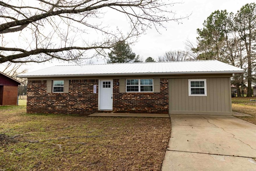 Completely remodeled and move-in ready, this Ozark home offers a rare opportunity to own an updated property under $130K. Major exterior upgrades include a durable metal roof and updated vinyl windows. Inside, you’ll find fresh paint, luxury vinyl plank flooring, updated lighting, and a bright open living and kitchen layout designed for comfortable everyday living. The kitchen features new cabinetry, stainless steel appliances, and generous counter space. A split floor plan provides added privacy, with a spacious primary bedroom offering exterior access to a private side patio. Two additional bedrooms allow flexibility for guests, family, or a home office. Additional improvements include a new water heater, updated fixtures, a modernized bathroom, and new flooring throughout. Conveniently located near schools, shopping, and local amenities. At $129,900, updated homes like this are hard to find in Ozark.