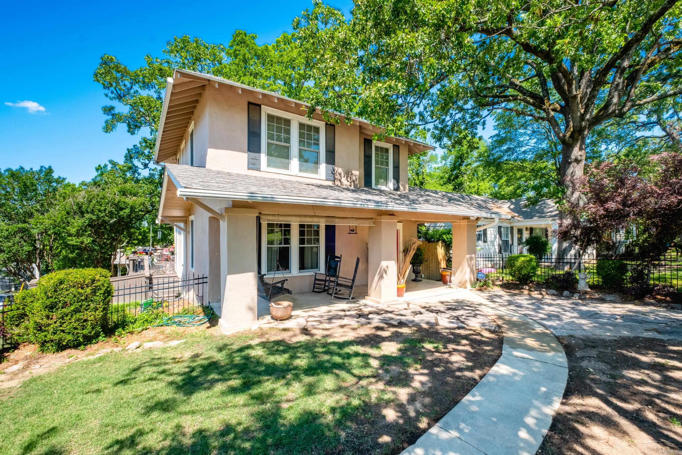 Quintessential 2-story Hillcrest American Foursquare on corner lot w/3 bedrooms & 2.5 baths. Two living spaces, separate dining room & eat in kitchen. Kitchen has quartz countertops, breakfast bar and stainless appliances. The den has two walls of windows with tons of natural light. All bedrooms up with incredible views of the city. Primary bedroom has walk in closet and primary bath has walk in shower. One guest room also has walk in closet and guest bath has original footed tub! The second guest room has elfa shelving system in closet. There are newer Pella windows throughout the home and a brand new roof! Outdoor living is incredible w/ fully iron fenced yard with antique iron gates. Large covered front porch in the front and a wrap around deck on the side and back leading to a tree house w/ Pella windows and electricity. Two car side entry carport with nice size storage room. This is a great sized corner lot and this home is literally 2 blocks from Kavanaugh - walking distance to all the stores, restaurants and festivities that Historic Hillcrest has to offer!