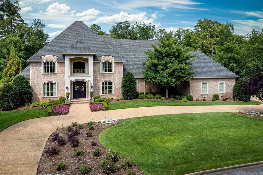 Timeless elegance and sophistication shows throughout this outstanding traditional home in a lovely gated Chenal golf course neighborhood. Thoughtful attention to every detail is displayed from the fantastic gourmet kitchen with top of the line appliances, tons of custom cabinetry and gorgeous granite counters to the hardwood and travertine floors that flow through the main level accenting the formal and informal living spaces. Light from the wall of windows fills the Primary suite with fireplace sitting area, spa bath and double closets. Four charming guest bedroom suites (one on main lvl), Bonus/game/media room with wet bar, office, planning area, full bar and huge laundry are just some of the other features. Covered and uncovered outdoor living space with pool, hot tub and outdoor kitchen overlooking Bear Den course. 4 car garage with storage. Come See!