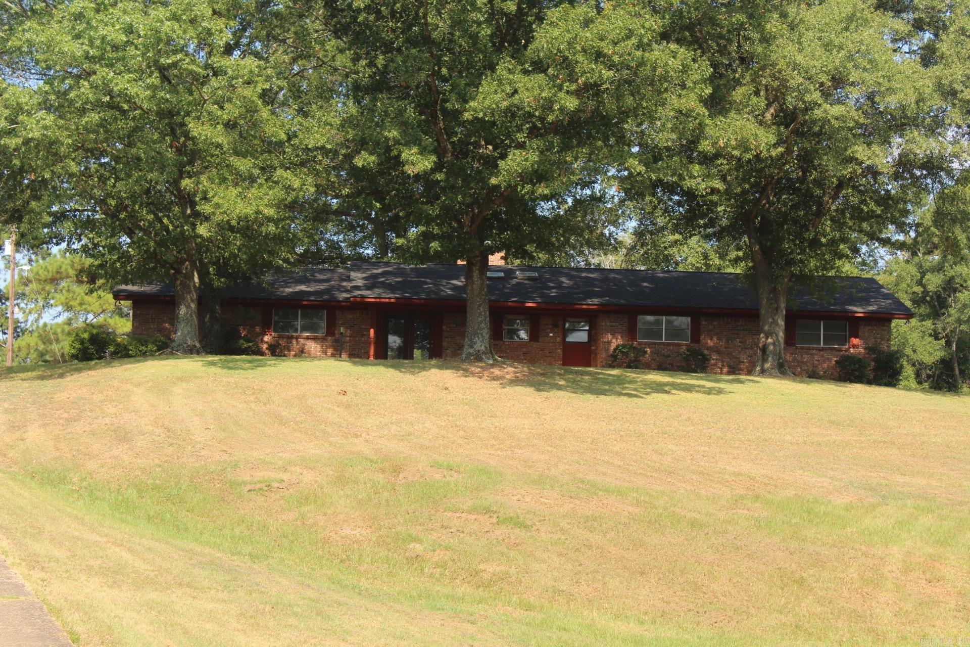 3 Bedroom, 2 Full Baths with approx. 2215 Sq. Ft. of living space situated on approx. 4.73 acres just north of town. Spacious family area features a vaulted/beamed ceiling with a massive fireplace and built-ins. Large master bath has double sinks. Home features a separate sunroom that also has a vaulted ceiling. Home has a Generac standby generator.