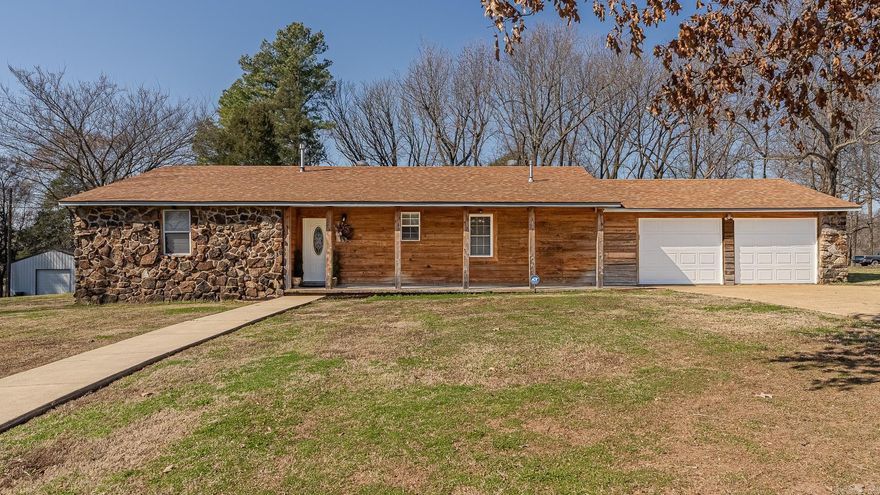 Introducing 41 CR 115 of Bono, AR, this rock and cypress house sets on 0.60 Acres +/-.  Providing 2,423 Sq Ft, a split floorplan that has two en-suites, a third bedroom, an office, a 1/2 bath for guests, as well as a partial basement.  The extra spacious primary suite has two walk-in closets,  is equipped with a walk in shower and a jetted tub.  The arched doorways, crown molding, curved tray ceilings, chandeliers and layout that flows, all add character to this house. This kitchen is well equipped with extra cabinet space and two built in wood swingout pantries.  A Spacious laundry room and additional storage room in the garage. Step outside and enjoy the backyard from the deck.  Conveniently located just outside of city limits of Jonesboro and Bono.  The 30' X 30' exterior shop has so much potential.  Call today to make an investment in tomorrow!
