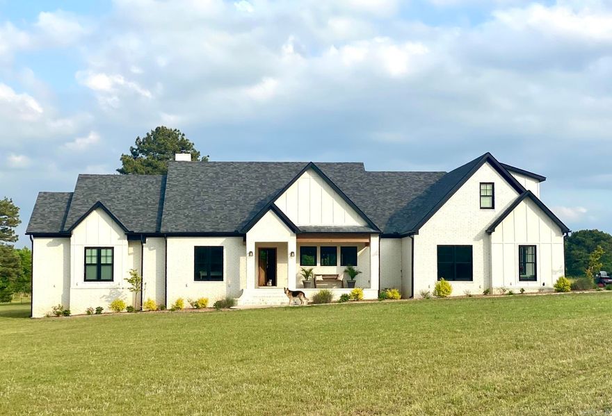 Welcome to peaceful country living with all the modern comforts in this stunning home built in 2018! Situated on 21.98 beautiful acres just outside the Searcy city limits with 3,029 square feet, this thoughtfully designed home features 4 bedrooms and 3.5 baths, with one bedroom currently serving as a spacious home office. The heart of the home is the incredible open living, kitchen, and dining area where large windows showcase breathtaking views of the surrounding property. Warm Saltillo tile, rich hardwood flooring and stylish finishes create an inviting atmosphere that feels both elegant and relaxed. The oversized primary suite is a true retreat featuring a luxurious spa-like bath with a soaking tub, expansive walk-in closets, and plenty of space to unwind. Two of the additional bedrooms each offer their own private bathrooms, providing comfort and privacy for family or guests. The oversized laundry room is exceptional with abundant storage and a convenient dog wash station. Additional features include a safe room located in the oversized two-car garage and a newly added 30x30 barn with tack room and 3 stalls. Welcome to your dream home with room to roam!!! See REMARKS!