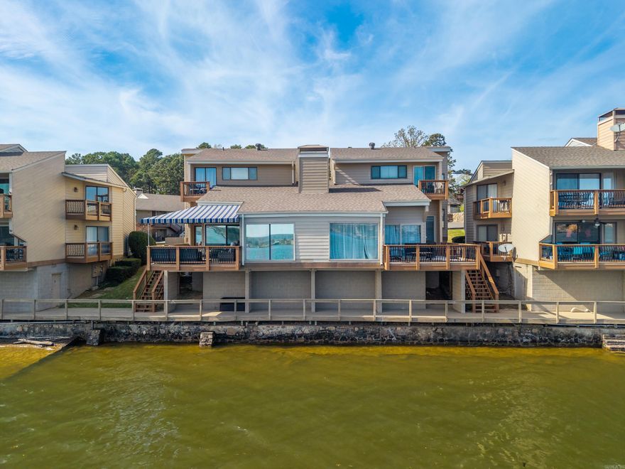 Main channel Lake Hamilton condo with "lake views that steal the show"!  Selling furnished, this condo features open-concept living, the space is designed for easy flow and relaxed lake life. Expansive deck for entertaining or unwinding, plus private stairs to the boardwalk that lead straight to your own boat dock. Clean, simple lake access—just step out and go. Short-term rentals are allowed, making this a strong investment opportunity or the perfect personal getaway with income potential. This beautiful North Shore complex is well maintained and also offers a beautiful pool to relax by after a fun filled day on the lake. "A Standout"!