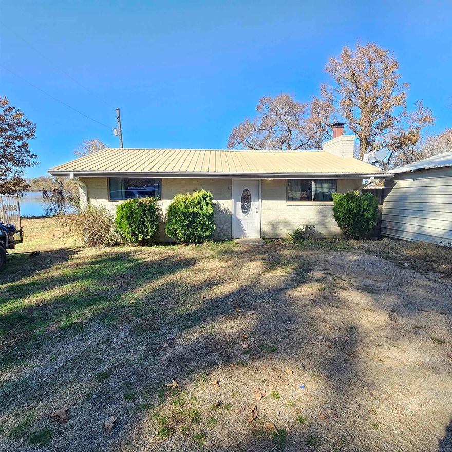Welcome to 129 Overcup Lake in Morrilton, Arkansas. This charming two-bedroom, one-bath home offers beautiful lake views and is zoned for a private boat dock, making it ideal for lake lovers and outdoor enthusiasts. Enjoy peaceful mornings or relaxing evenings in the bright sunroom overlooking the water. The home features a comfortable layout with a full kitchen and inviting living space, perfect for a weekend retreat, full-time residence, or investment property. Situated just minutes from the public boat ramp, this property offers easy access to boating, fishing, and all the recreation that Overcup Lake has to offer. With its quiet setting and convenient location near Morrilton’s local dining and shopping, this home combines the tranquility of lake life with small-town charm. Come experience the beauty of lakefront living at 129 Overcup Lake—where comfort, convenience, and nature come together perfectly.