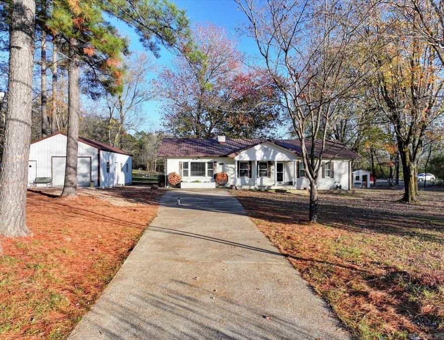 Welcome to your small farm near downtown Hot Springs with approx. 5 acres and 3 homes including a main house, 2 guest houses, detached shop (20x40) with electric and plumbing in place for full bathroom, and various farm features like a horse barn, goat pen, chicken coop, and additional outside storage building it's perfect for someone looking for a mix of rural tranquility and the convenience of being close to downtown or Hot Springs Village.  The fact that both guest homes are already functioning as a short-term rental (STR) could be a great opportunity for generating income while enjoying the property.  The walking trails and cleared land provide plenty of space for outdoor activities, gardening, picking your fruit trees (peach, pear, apple, plum trees and Black walnut) or expanding the farm.  Property has well water as a bonus feature for maintaining the farm or gardening.  The main house features 3 beds 2 bath, new floors and fresh paint,  a den with a wood burning stove for those cold nights offering that cozy feel and energy-efficient heating.  Each guest house offers 1 bedroom and 1 bath.  Agents see Remarks.