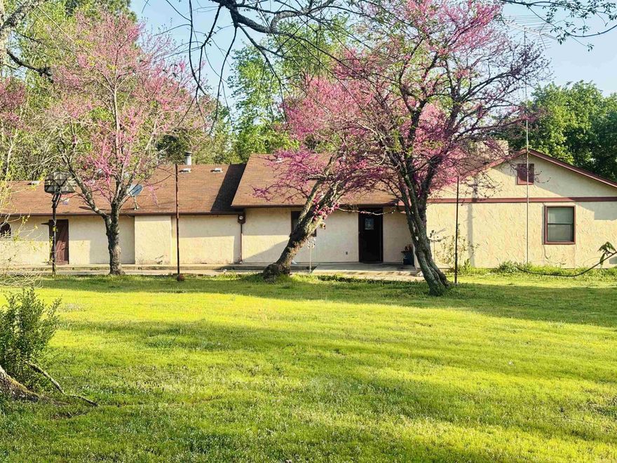 3 bedroom, 2 bath, Spanish-style home just minutes from Mena City Limits! Home features large bedrooms and closets, kitchen/dining area with buffet for entertaining, and expansive patio, and storm cellar. Includes a one-car garage, storage building, some vaulted ceilings, fireplace and a wood-burning stove. All sits on 5.46 acres that feels like country living with conveniences of living in town. Subject to right of way of Dallas Lane.