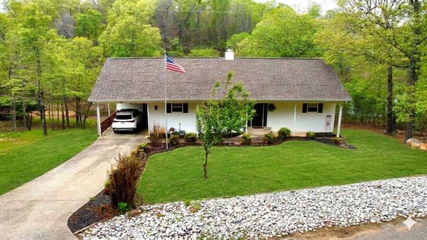 Charming lakefront home built in 2001 with TWO LAKE LOTS!!  Located in Cherokee Village, AR on Lake Aztec. The open-concept living area features vaulted ceilings, large windows with peaceful lake views, and a stunning native stone fireplace with gas logs. The kitchen has been updated with new concrete countertops, a new sink, and professionally painted cabinets. New flooring runs throughout the home, perfect for low-maintenance lake living.  The primary suite & laundry are conveniently located on the main level. The finished walk-out basement provides excellent space for guests &  entertaining, offering a large family room, recreation room, two bedrooms, a bonus room currently used as a home gym, a full bath, an outdoor workshop, and a storage area located off the lower deck.  Enjoy tranquil views & direct lake access with your own private boat dock. Just minutes from a golf course, this property offers the perfect balance of relaxation and recreation. Lake Aztec is a great fishing lake and just one of 7 lakes located in Cherokee Village, along W/ 2-18-hole golf courses, recreation centers, and pools. Minutes to Spring River and South Fork River for great canoeing & fishing.