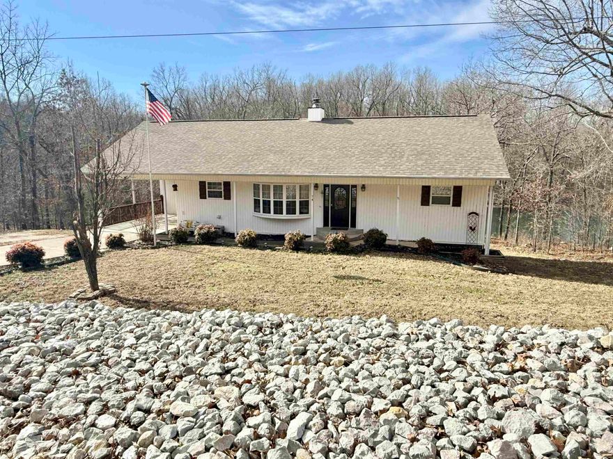 Charming Lake House Built in 2001 that  has been recently updated. Beautiful open living area featuring vaulted ceilings, large windows with peaceful lake views, and a beautiful native stone fireplace with gas logs. The kitchen features new concrete countertops, new sink and professionally painted cabinets. All new flooring throughout the home—ideal for easy lake-day living. The primary suite and laundry are conveniently located on the main level. The finished walk-out basement offers plenty of space for guests and gatherings, including a huge family room, recreation room, two bedrooms, bonus room currently being used for a home gym , full bath, outside workshop, and storage area off the bottom deck. You will enjoy the wonderful peaceful views and direct lake access with your own boat dock. Located just minutes from a golf course, this home offers the perfect blend of recreation and relaxation.
