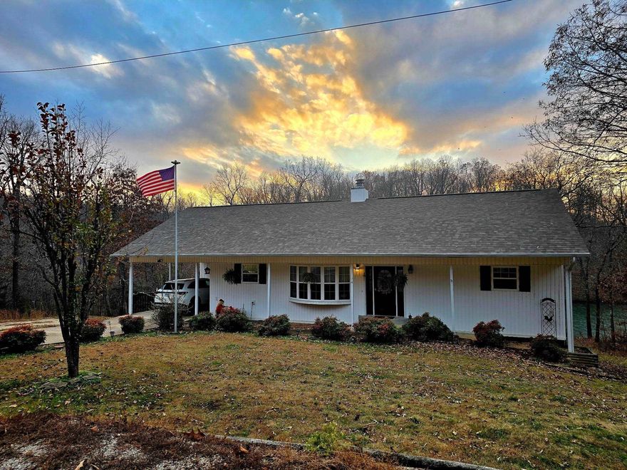Charming Lake House Built in 2001 that  has been recently updated. Beautiful open living area featuring vaulted ceilings, large windows with peaceful lake views, and a beautiful native stone fireplace with gas logs. The kitchen features new concrete countertops, new sink and professionally painted cabinets. All new flooring throughout the home—ideal for easy lake-day living. The primary suite and laundry are conveniently located on the main level. The finished walk-out basement offers plenty of space for guests and gatherings, including a huge family room, recreation room, two bedrooms, bonus room currently being used for a home gym , full bath, outside workshop, and storage area off the bottom deck. You will enjoy the wonderful peaceful views and direct lake access with your own boat dock. Located just minutes from a golf course, this home offers the perfect blend of recreation and relaxation.