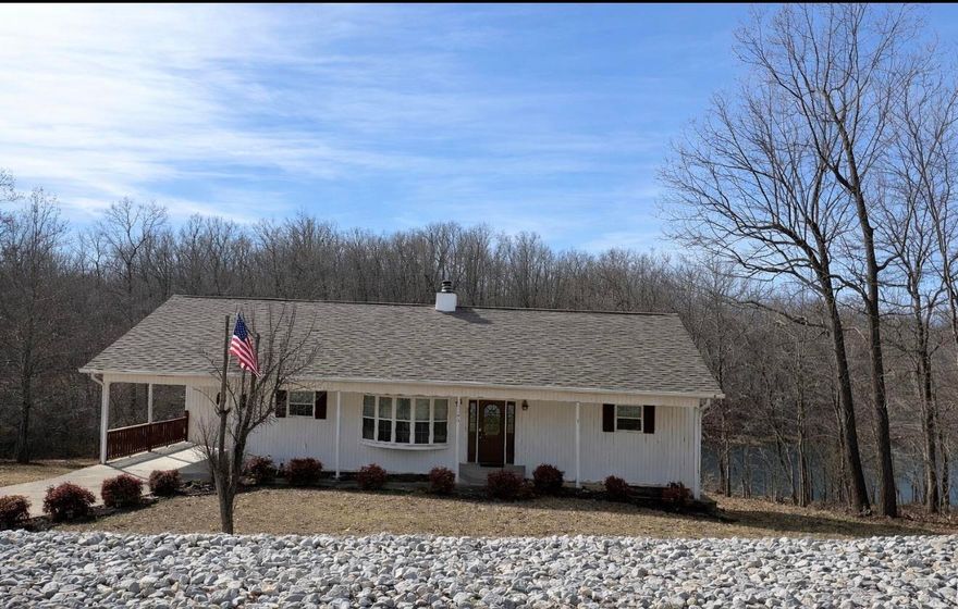 Charming lakefront home built in 2001 and recently updated. Located in Cherokee Village, AR on Lake Aztec. The open-concept living area features vaulted ceilings, large windows with peaceful lake views, and a stunning native stone fireplace with gas logs. The kitchen has been updated with new concrete countertops, a new sink, and professionally painted cabinets. New flooring runs throughout the home, perfect for low-maintenance lake living.  The primary suite and laundry are conveniently located on the main level. The finished walk-out basement provides excellent space for guests and entertaining, offering a large family room, recreation room, two bedrooms, a bonus room currently used as a home gym, a full bath, an outdoor workshop, and a storage area located off the lower deck.  Enjoy tranquil views and direct lake access with your own private boat dock. Just minutes from a golf course, this property offers the perfect balance of relaxation and recreation. Lake Aztec is a great fishing lake and just one of 7 lakes located in Cherokee Village, along with 2-18-hole golf courses, recreation centers, and pools. Minutes to Spring River and South Fork River for great canoeing & fishing.