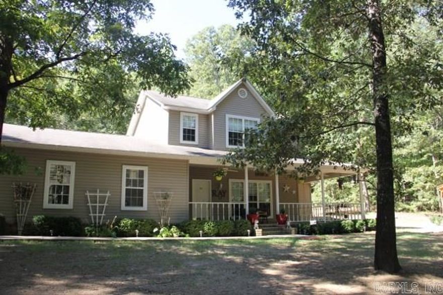 Love the woods and dislike being in a subdivision then this is the house for you!  This house sits on 3 wooded acres, has a wrap around porch, and a new gazebo in front yard.  Wildlife can be see in the yard.  The back yard is newly fenced.  Property has a large shop with electricity.  Kitchen has stainless steel appliances and hardwood flooring.  Home has been painted throughout including the shop, French drains have been installed, and the shop has been finished out.  QUALIFIES FOR RD LOAN!