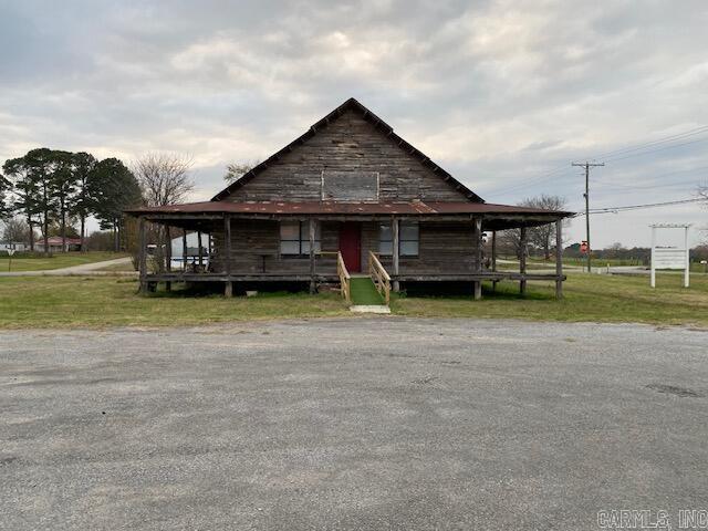 Rustic building located on busy Hwy 25 and Fred St. This rustic building features log slab siding and large porch with vaulted ceiling and outstanding woodwork. This property has an excellent location. Land is coming out of larger piece; survey has been done to determine size. Property is agent owned