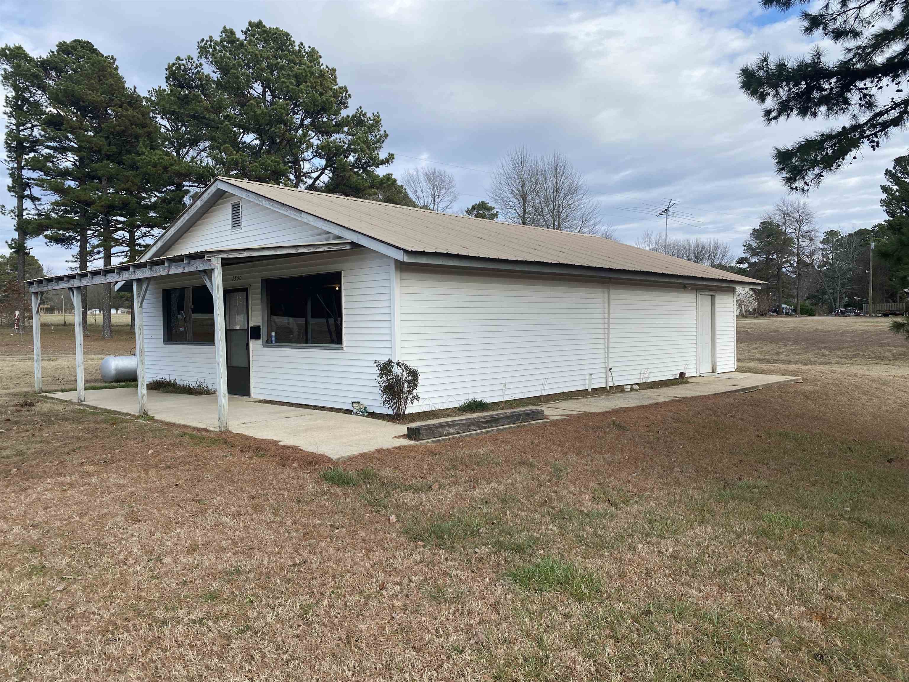 This is a great property on a busy highway. Building has lots of options. Could be used as a business, house, shop, storage ect. Approximately 2 acres with plenty of room for yard equipment, boats, or anything you desire. Drive by and give us a call.