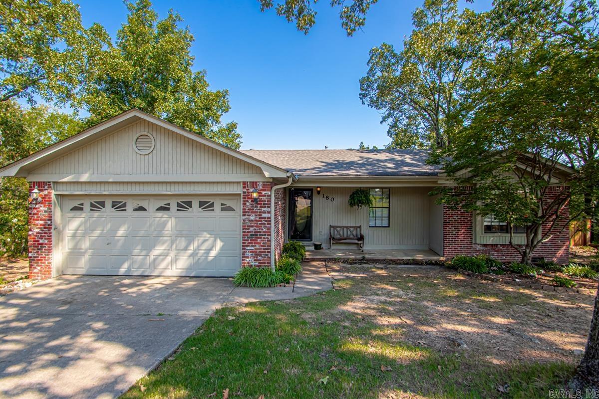 Talk about a serene setting! This wonderful one-level home sits at the end of a dead end street and backs up to woods! Home sits on approx .43 acres and extends way beyond the privacy fence in the back. Property survey provided upon request. Great room and primary bedroom have beautiful vaulted ceilings. Open floor plan. 2020 new hand-scraped hardwoods installed throughout excluding tile in kitchen & baths. Enjoy the kitchen with a sit-down bar, stainless steel gas stove & microwave! Primary bedroom has a walk in closet and two regular closets. Big patio in back makes for awesome entertaining! Brick & siding exterior. Roof approx. 10 years old, heat and air approx. 5 years old. Hot water tank 2023. Big walk-in crawl space under the house. This could be your new home! Come see!