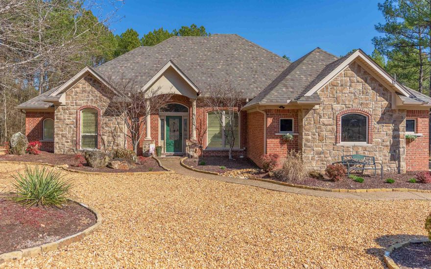 Welcome to this beautifully updated 4 bedroom, 3 bath home located on the popular East End of Hot Springs Village.  Step inside, and you'll immediately appreciate the warmth of the home's design.  Features include volume ceilings; crown molding/trim; granite stone fireplace; gleaming wood flooring; and large windows that provide an abundance of natural light highlighting the details of this lovely home.  Gorgeous maple cabinetry in the kitchen and baths complements the home's inviting atmosphere. Additional features include an updated kitchen with quartz countertops; large pantry; spacious primary bedroom with remodeled private ensuite bathroom; separate laundry room; 3 car garage (1 converted to heated/cooled workshop) and covered and uncovered outdoor patios for outside enjoyment.  The home is built on a .34 acre level lot with secluded back yard and water feature that creates a peaceful and tranquil ambiance that's hard to come by.  For added privacy, the level lot next door is available separately for sale.  Don't miss your chance to experience the serenity of this natural setting and the beauty of this well-appointed home. Agents see Remarks for additional details.