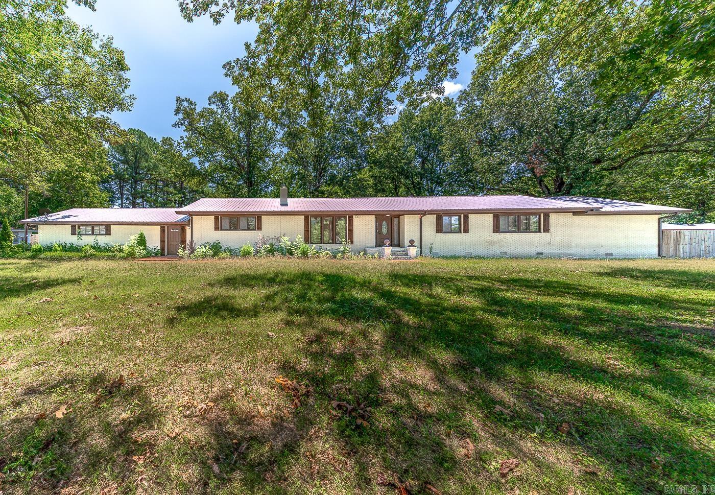 Welcome to market this charming and spacious home that is now available at an unbeatable price. OPTION TO ASSUME THE MORTGAGE AT 4.25% RATE. Well maintained ranch-style brick home on .91 acres near Weiner Public Schools. This 3207 Sqft house is located on a secluded drive and features a cozy living room w/ gas fireplace, Spacious Den w/ a fireplace, Sunroom, Dine-In Kitchen, Separate Dining Room that opens up to an updated kitchen w/ tons of cabinets space & granite counters, Hardwood floors throughout, 2.5 bathrooms updated, new fixtures and two newer hot water tanks. The Owners suite includes an elevated sitting area, updated full bathroom, and a large walk-in closet with a storm shelter for safety. 2 car side load garage + a large detached garage/workshop. The lush fenced in backyard is perfect for outdoor activities and gardening and features a screened in patio. Stainless steel fridge, stove, dishwasher, microwave, washer, dryer remain at the property in as-is condition. Please schedule your private tour today. Motivated Sellers will entertain all offers.