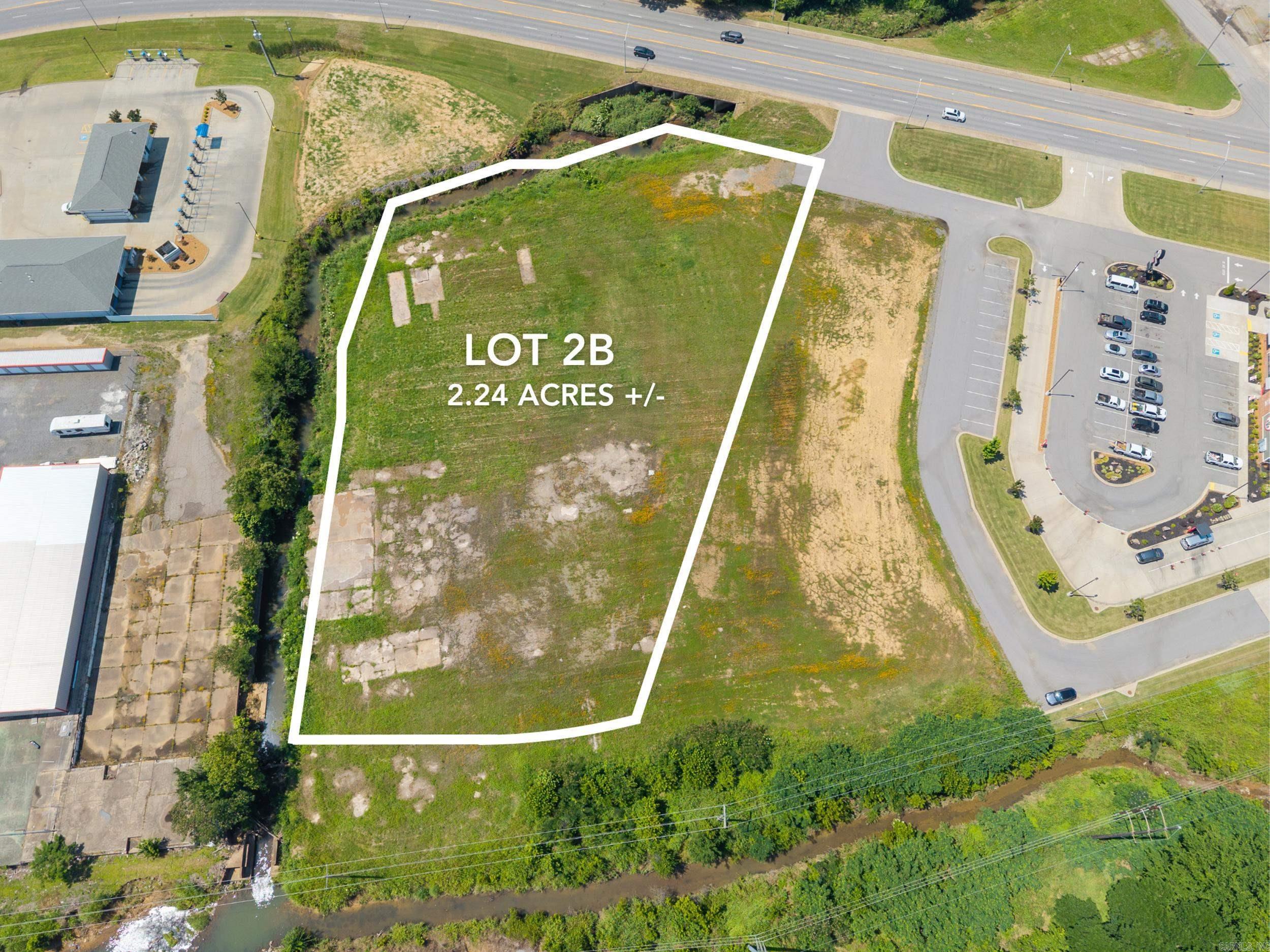 This premier 2.24-acre development site in downtown Searcy presents an outstanding opportunity for commercial investment. With approximately 300 feet of prime frontage along Beebe Capps, the property benefits from exceptional visibility and high daily traffic counts. Zoned C-4, it offers versatile development possibilities, supported by readily available utilities to facilitate efficient construction. Strategically positioned near Harding University, the Walmart Distribution Center, and other major industrial operations, the site is nestled among established businesses, including Slim Chickens, McDonald’s, Burger King, and Topicals Smoothie Cafe. Lot 2B, encompassing 2.24 acres, is available for individual purchase or can be combined with the adjacent 1.9 acre Lot 2A for expanded development potential, making this an ideal choice for visionary developers seeking a high-impact location. Phase 1 & 2 Environmental passed in 2025.