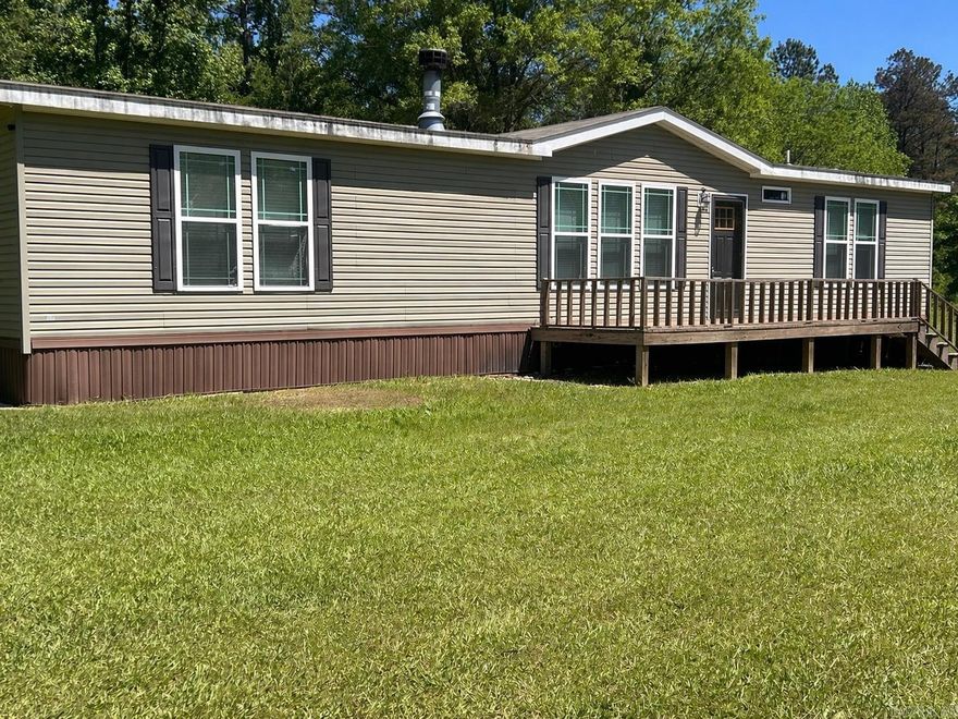 Peaceful country living outside of the city limits, this 2017 mobile home sits on 2 acres and offers 3 bedrooms and 2 baths with a spacious split floor plan.  Enjoy a large master suite tucked away from the other bedrooms, featuring a beautiful master bath with soaking tub, walk in shower, double vanity, large closet.  Cozy up by the fireplace for family night or utilize the open concept for entertaining.  An added value to this home is the new chamber septic system.  This property is part of, Camden, AR the Harmony Grove school system with bus route access.  For Google Maps/Apple Maps use 134 CR 594