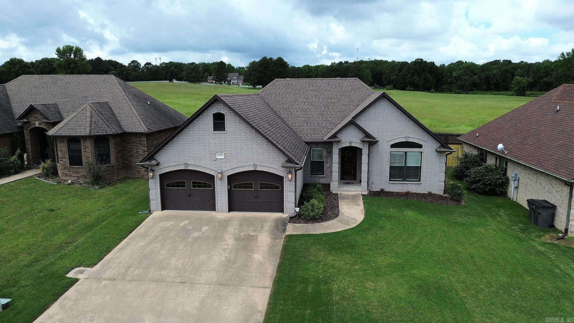 New to the Market! This beautiful brick home blends timeless elegance with modern design in a spacious open floor plan. Inside, you’ll find gorgeous hardwood floors, 9-foot ceilings, and detailed crown molding that add a touch of sophistication throughout. The kitchen is a standout with granite countertops, a tiled backsplash, a large island with sink, and a walk-in pantry—perfect for storage and organization. The main bedroom suite is a true retreat, featuring a tray ceiling, a large walk-in closet, and a glamorous en-suite bath with dual vanities, a separate tub, and a walk-in shower. Additional bedrooms are generously sized, offering plenty of space for family, guests, or a home office. Step outside to enjoy the fenced backyard that backs up to an open field, providing both privacy and a peaceful view. Additional highlights include plantation blinds, professional painting in 2023, and thoughtful upgrades throughout. Don’t miss your chance to own this exceptional, move-in ready home—schedule your private tour today!