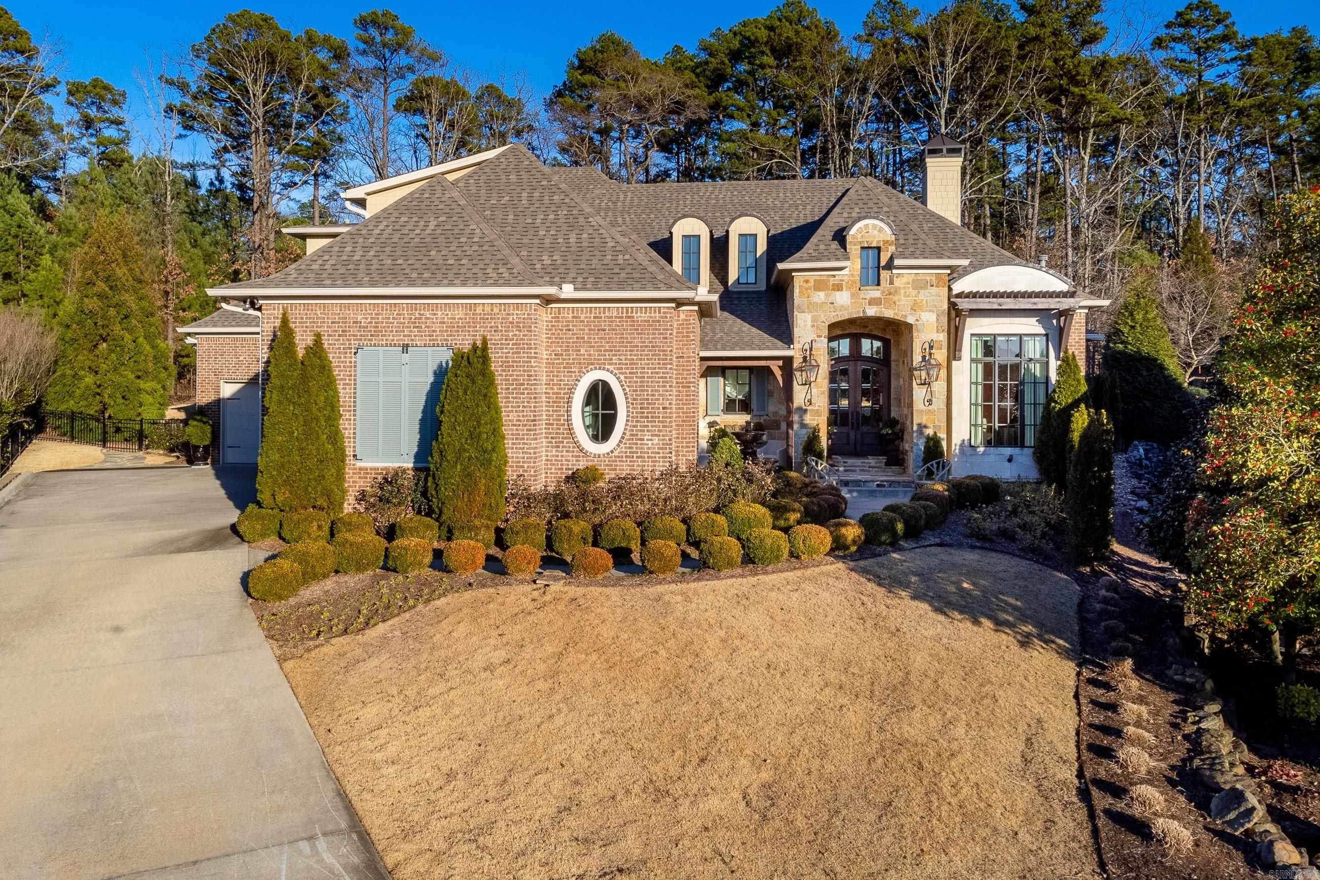 Spectacular home in The Arbors of Chenal with numerous recent updates! Fabulous floorplan w/ gorgeous custom décor. Enjoy the very best in family living and the perfect setting for entertaining. Stunning entry, Handsome hm office. Wonderful living space with beamed ceiling and fireplace overlooking backyard oasis. Elegant formal dining adjacent gourmet kitchen. Luxurious master suite on the main level along with spacious guest suite. Upstairs: 2 bedrooms, 1 bath. Covered terrace w/Grill and fireplace. Gated