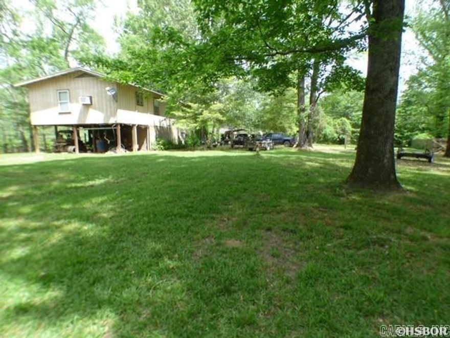 Cabin hideaway on Champagnolle Creek with miles of fishing, duck hunting in Cypress trees galore , hunt the 16000 acres on the Moro Big Piney Refuge requires a permit from AGFC, Rural Water 7 Trash pickup.  Located between El Dorado & Hampton. Call Gary for an appointment to see this getaway.