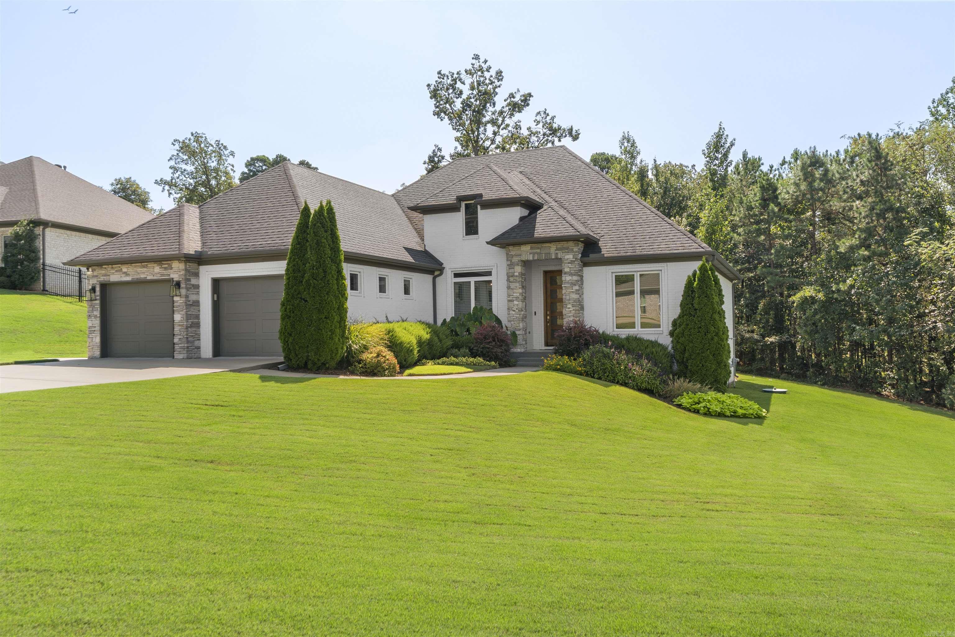 Modern, elegance and charm all in one beautiful package. This stunning home in the gated community of Lochridge Estates has so many wonderful upgrades. The ultra functional kitchen includes ceiling height cabinets, stunning granite tops, upper end appliances and a built-in coffee bar area. Other upgrades include brand new carpet in guest rooms, hardwoods in all the common areas, the executive office and the primary suite. The luxurious master suite features a lavish bath space and generous size closet. Outdoor you will find an expansive deck area that is truly a lush oasis with unbelievable landscaping. Too much to list. This is a must see in person.