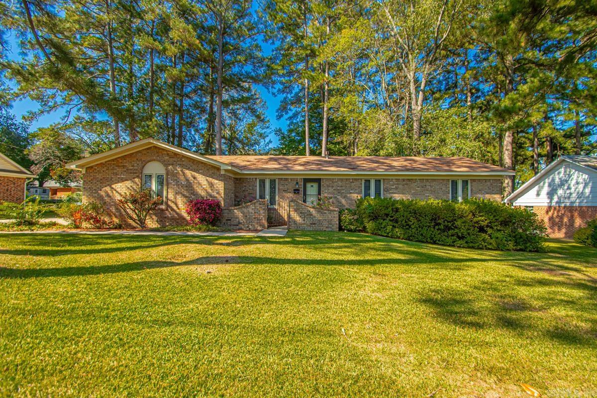 This charming home features a formal living area as you enter from front door but also offers a den that gives gives ample living space for families or an individual. It is nestled on a large lot with of outdoor space for gardening, entertaining or just relaxing & enjoying nature! What an opportunity to personalize the space!! With its classic design and generous lot size, this home is a blank canvas awaiting your vision. The kitchen area is super with an island! Three bedrooms & two full baths complete this wonderful home. The covered patio & extra storage room outback is certainly an extra!! Great location & school district! Come take a look!!
