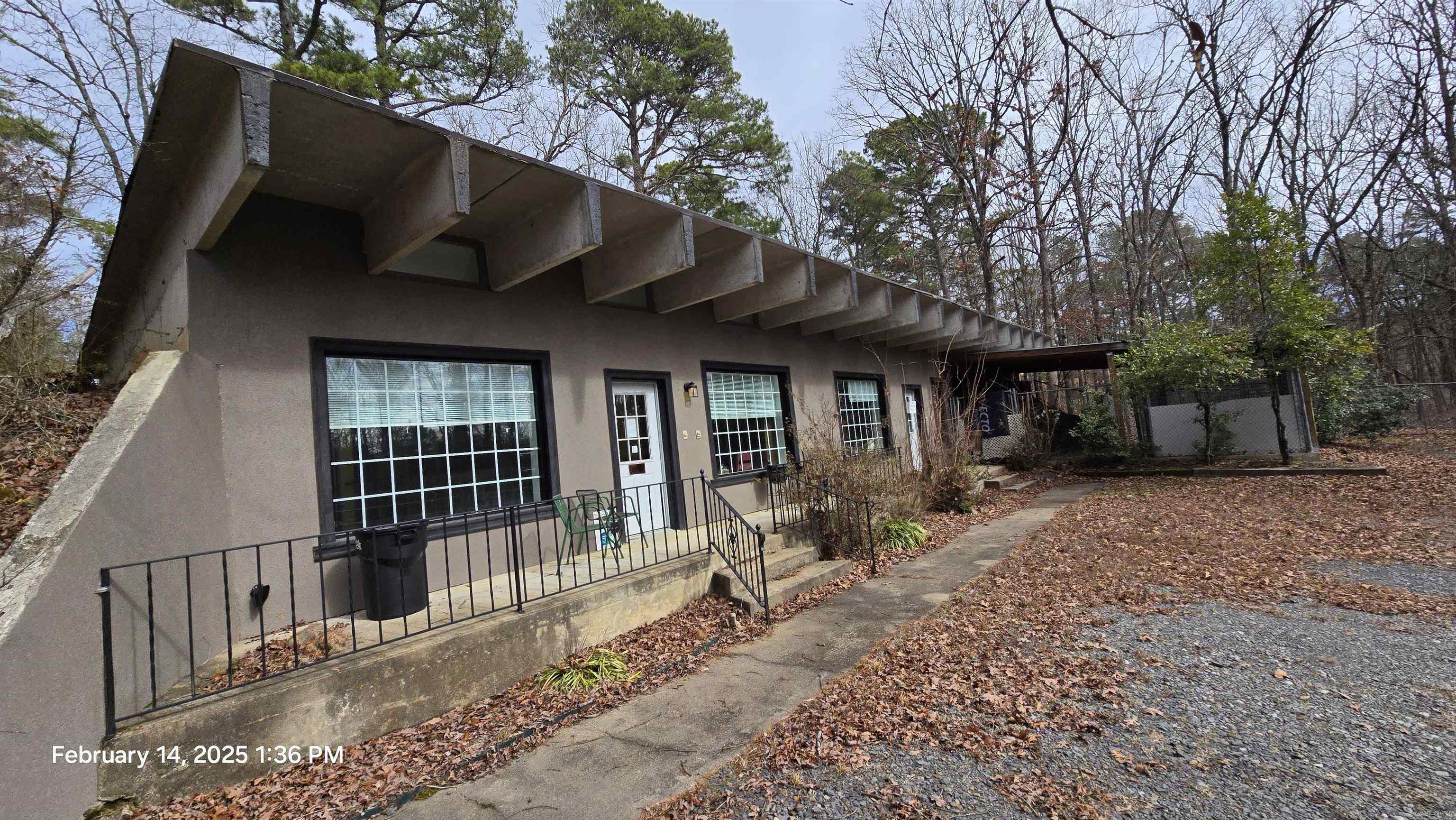 Built for any season, this buildings 4 walls and roof are all built with concrete on the exterior, making the interior ready for any layout you & your builders can dream of! Possibly could be come an office, warehouse, shipping center, retail shop, maybe build your home on one end while working out the other side! Property sits on 1 acre m/l, has fenced in area for pets & is very secluded!