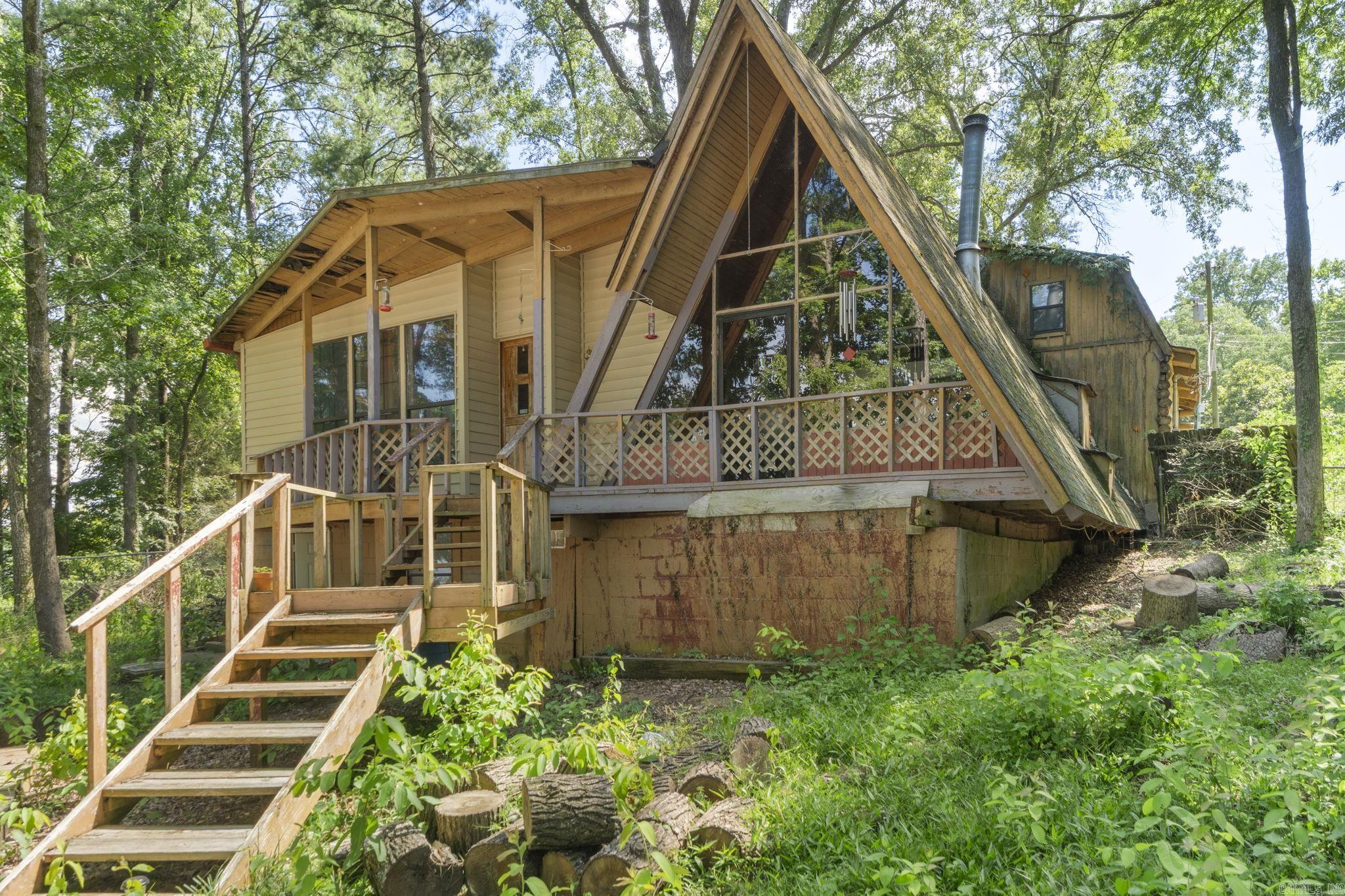 Escape to the lake with this super cute A-frame home on beautiful Harris Brake Lake! Harris Brake is well known for its bluegill, channel catfish, crappie, hybrid striped bass, largemouth bass and redear sunfish among others. This charming 1 bed, 1 bath retreat is full of character and perfect as a relaxing family lake house, fishing lodge or an ideal Airbnb getaway. Enjoy stunning views from the large windows that frame the lakefront setting, letting in plenty of natural light. The covered sitting area is perfect for morning coffee or evening sunsets, and the private dock makes it easy to fish, swim, or launch a kayak right from your backyard. Whether you're looking for a peaceful escape or an income-producing short-term rental, this lakefront gem checks all the boxes! No seller property disclosure available.