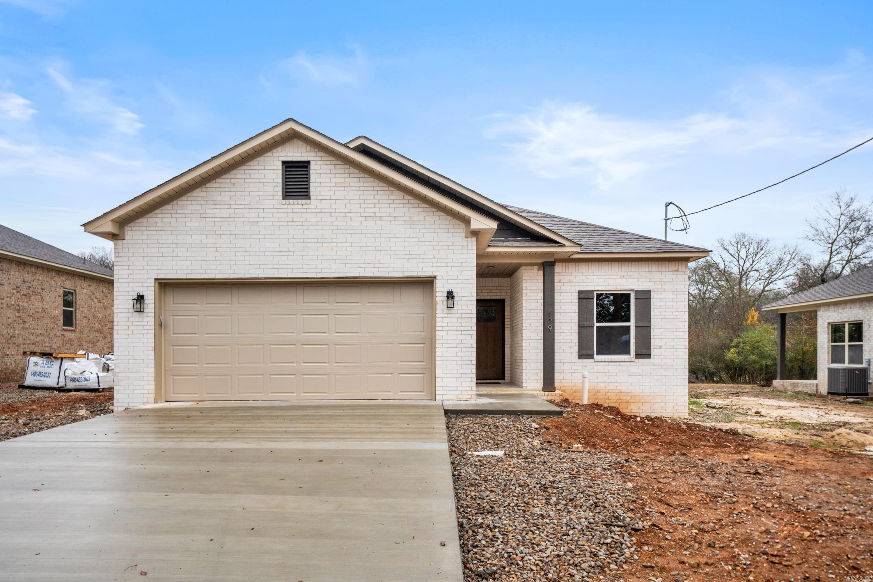 Immaculate custom-built, new construction home is a true showcase of modern luxury and craftsmanship. This 3-bedroom, 2-bath all electric home, including the water heather & central heat, offers the perfect blend of style, comfort, and functionality. With luxury vinyl plank flooring by Shaw and granite/quartz countertops in the kitchen/bath, the interior is designed with an elegant, contemporary feel. The home features 9-foot ceilings that create an airy, open atmosphere, while insulated doors and walls enhance energy efficiency. The primary suite is a private retreat, complete with a luxurious walk in shower. The exterior is equally impressive, with a striking brick facade with vinyl soffit & metal fascia, and a fiberglass front door that provides both durability and curb appeal. Enjoy the convenience of a 2-car garage with insulated walls & doors, a covered back patio, and a sprinkler system on its own meter, ensuring the lush landscaping is always well-maintained. Whether you're looking for a stylish new home or a practical space with all the modern amenities, this property is a must-see. Schedule a tour today to experience the comfort and quality this home has to offer!