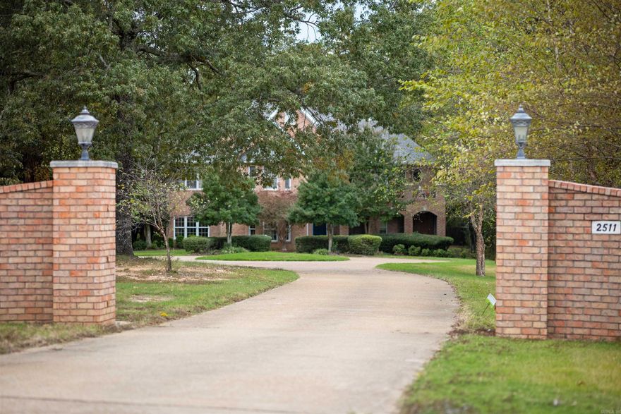 An extraordinary private estate, thoughtfully designed for comfort, elegance, and retreat. Situated on 9.25± acres within Jonesboro city limits, this remarkable residence offers over 6,500 square feet of beautifully appointed living space, providing a rare balance of privacy and convenience. The home has been thoughtfully remodeled, featuring a stunning kitchen equipped with Electrolux appliances and designed to serve as a central gathering space. Heated floors enhance everyday comfort, while abundant storage and generous closet space throughout the home.  The primary wing serves as a true sanctuary, featuring a private balcony overlooking the wooded surroundings, a walk-around closet, and a spacious, spa-like bathroom. All additional bedrooms are generously sized with large closets, offering comfort and flexibility. An upstairs living area provides space for an office, music room, or additional lounge, while an unfinished area offers potential for a custom theater or media room. Perfect for both entertaining and everyday living, this estate offers a sense of peaceful escape rarely found inside city limits—yet remains just minutes from all that Jonesboro has to offer.