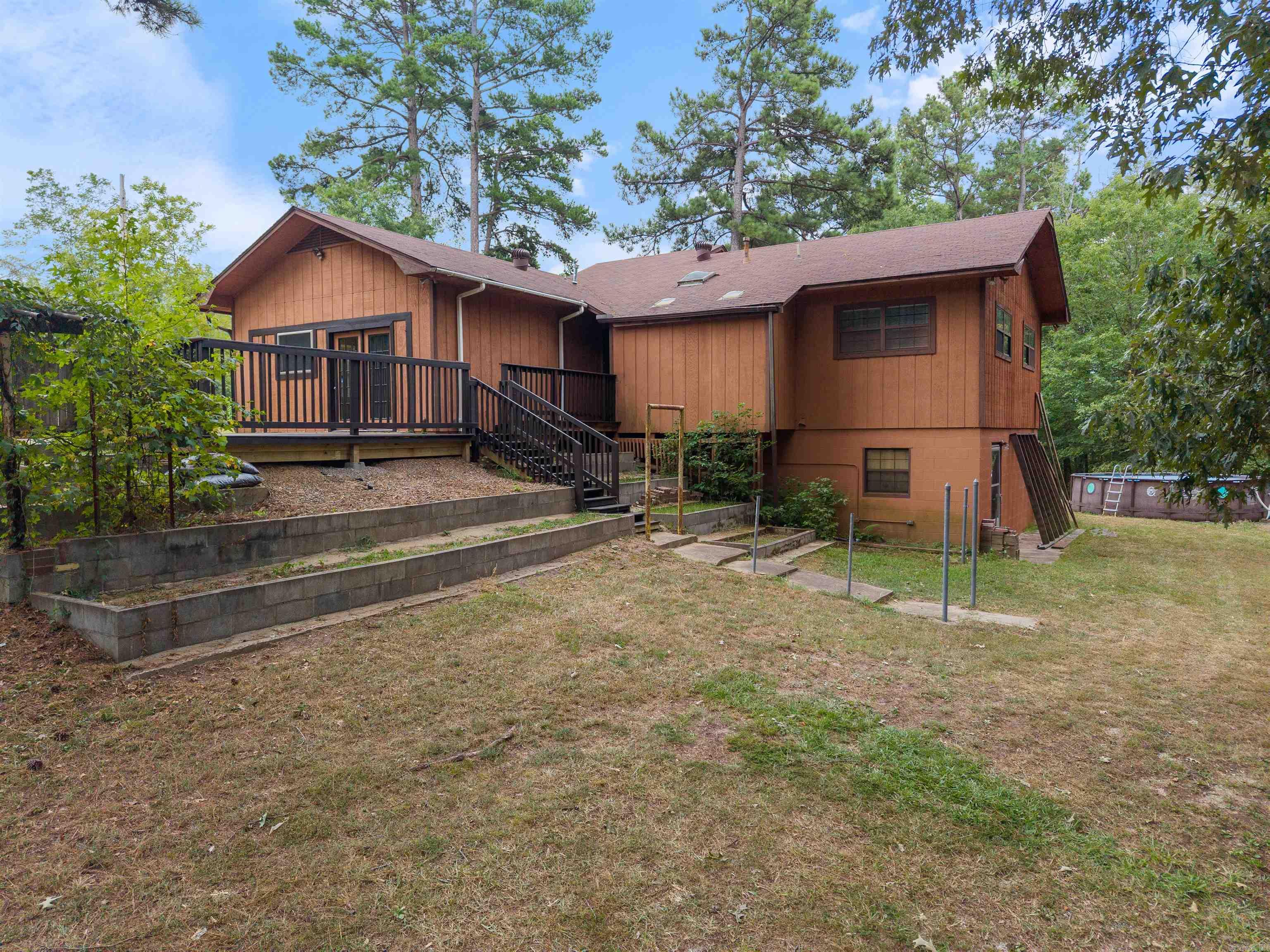 Welcome to 7035 Point View Road, a beautiful property offering the perfect blend of comfort, functionality, and room to roam. Situated on 5 serene acres in the Glen Rose School District, this home is ideal for those who want space—both inside and out. Inside, you’ll find 4 bedrooms, plus a flex space that could serve as a 5th bedroom, office, or hobby room—giving you the versatility you need. The floor plan is designed for easy everyday living while providing plenty of space for gathering and entertaining. Step outside and enjoy warm Arkansas days in the above-ground pool, or get creative in the detached shop with a bathroom and a loft—perfect for storage, projects, or even a future studio. The property’s acreage provides endless possibilities for gardening, recreation, or simply soaking in the peace and quiet of the countryside. The entire 5 acres is fenced, with open space near the house, and separate dog run for your 4 legged friends (or feathered - your choice!) Whether you’re looking for room for your family, a place to keep animals, or just a private retreat close to town, this home offers it all. See agent remarks for even more details!