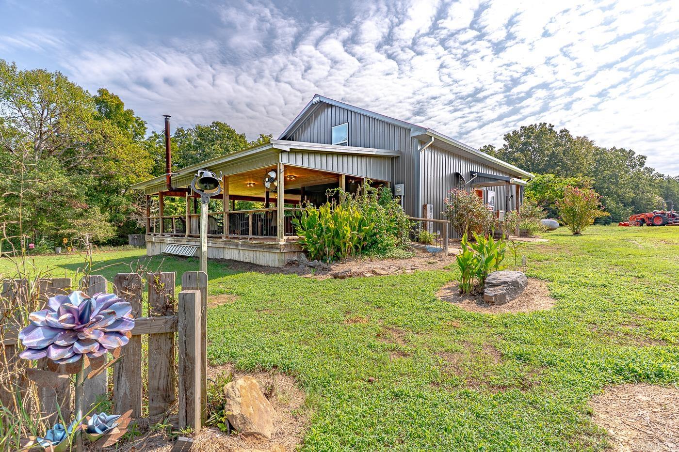 Welcome to Market 7135 Hwy 124 of Quitman, AR within the Quitman School District. Situated in Van Buren County on 33.68 +/- acres w/ 900 +/- linear ft of Cadron Creek frontage and apx. 8 ac of pasture and 24 ac of timberland is a 2018 Barndominium built w/ love, wrapped in metal and accented by a 2022 built 820 sf covered deck, covered front patio w/ wood door, and guttering. The interior features 1,650 sf of well laid out living space over 2 floors. The main level holds an open concept living/kitchen area w/ vaulted ceiling, bar seating, and stainless steel appliances, a Master bedroom w/ en-suite w/ shower/tub combo & dual vanity, and utility room. The 2nd floor holds 2 bedrooms & ample storage space. The grounds feature a 24x40 wired shop on slab w/ 2 attached storage containers, 265 ft well, 1k gallon septic tank, deer stand, feeder, picnic area, fruit trees, and direct access to hunting, fishing, and kayaking. You'll love that the property has fiber internet and city water. Enjoy ranch style living while being conveniently located apx. 30 miles from Searcy & Conway and 20 mins to Greers Ferry Lake. Call today to schedule your tour and make this one of a kind property your own.