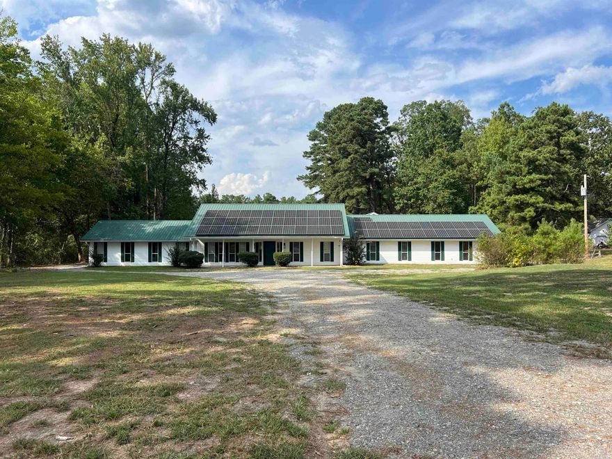 Spacious and full of charm, this four-bedroom, three-and-a-half-bath home sits on nearly four acres with a beautiful pond and comes equipped with paid-off solar panels for energy efficiency and peace of mind. Inside, the large master suite features a sunken tub/shower combo and generous walk-in closet space. The expansive dining and living room combination offers plenty of room for gatherings and entertaining. On the west side of the home, two spare bedrooms each enjoy their own private bathrooms, while a fourth bedroom off the hallway is serviced by a convenient half bath. Outside, the property includes a large shop and additional storage off the carport, perfect for hobbies, tools, or equipment. With space, functionality, and modern efficiency, this home is ready to welcome its new owners.  Home qualifies for rural development financing which could mean zero down payment.