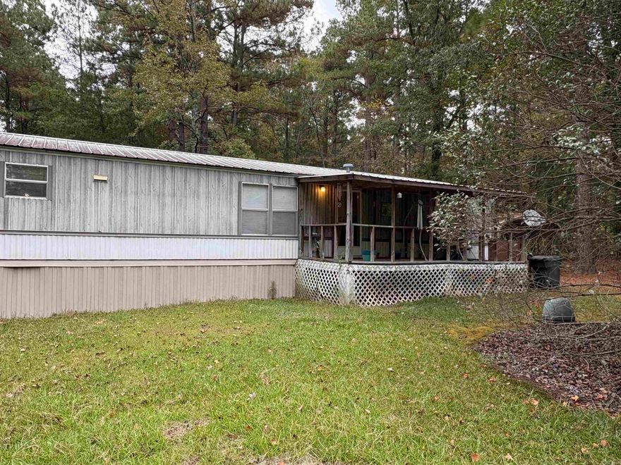 You will not find a 2004 model mobile home in this great of shape!  I sits on a busy highway but is separated by by a strip of timber and a constant running spring.  Don't miss out on this prime opportunity at a great price for a nice home with acreage!