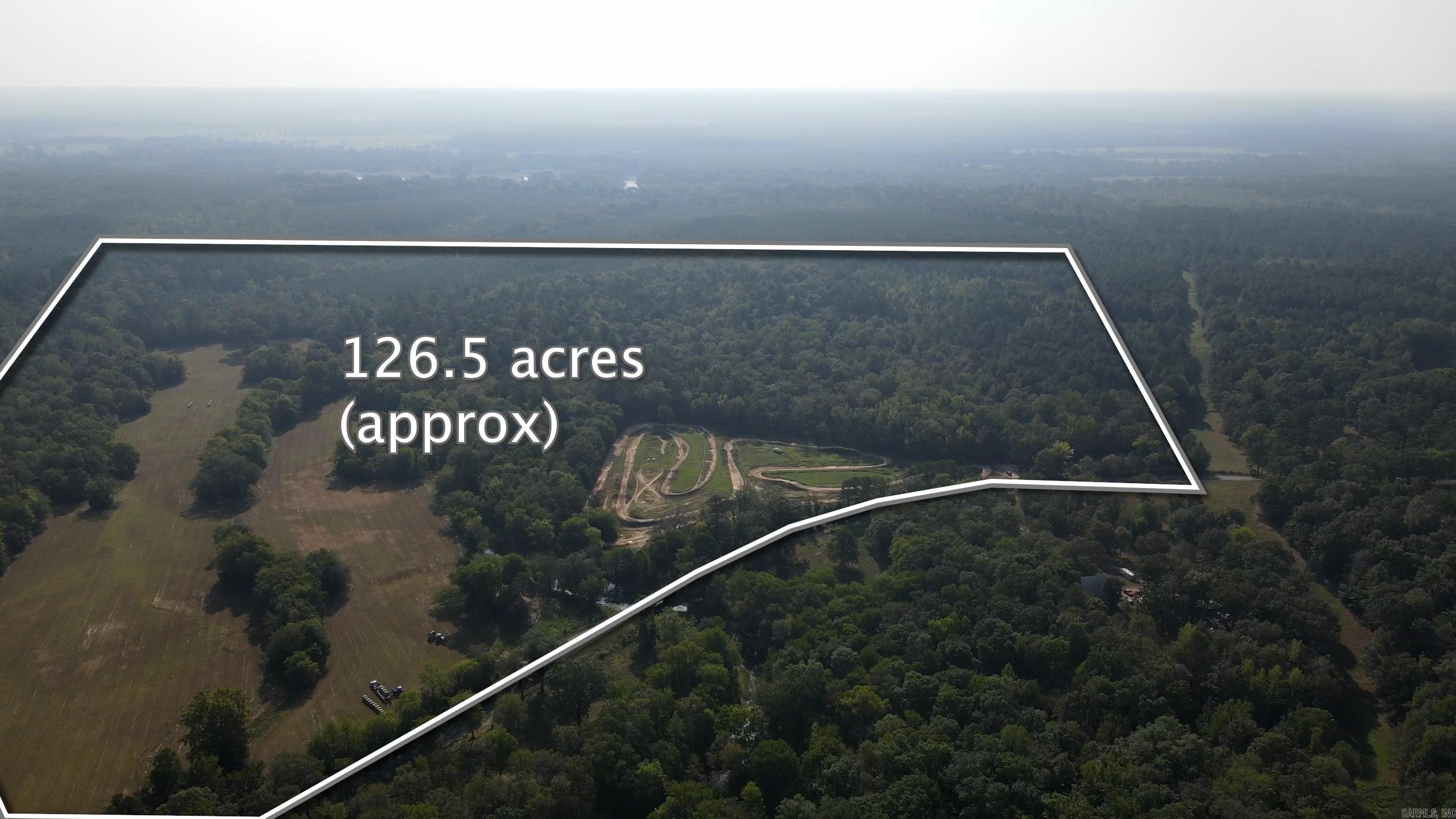 Beautiful Property with Prairie Bayou running through the center. Located about 20 minutes from Benton and 15 from Arkadelphia. Has an amazing motor-cross track on site with numerous trails cut throughout for hiking, biking or any other type of motorized toys, fabulous pasture land, is in a flood plain due to the proximity to the Creek but has high areas to sit a Grand Dream Home. Or could be utilized for hunting, fishing, camping. You dream it this could be the spot. Come see for yourself.