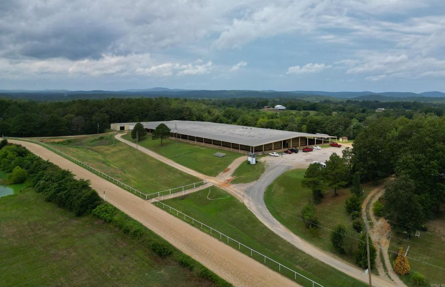 This one is a one-of-a-kind in Arkansas. It has a full sized sanctioned race track. The barn included 72 horse stalls, 3 hot and cold showers, rehab lap pool, and a warm up track under one roof. There is a Hay and Equipment barn separate from horse barn. It comes with some equipment to maintain the track and the property. There is a water well onsite, 2small apartments in the main barn as well as an office. Don’t miss out on your chance to own this! Call and set up your showing today!  There is so much extra information and potential in this property with just a short visit!