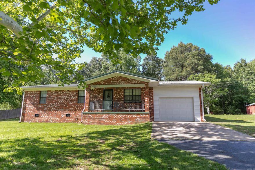 Charming home with a country feel on 1 acre. This home has the open space you're looking for with practical amenities. This well maintained property features beautiful hardwood floors, a durable metal roof, and a spacious one car garage. Outside you will find a large barn, storage shed, and a storm shelter. You'll have plenty of room for hobbies and storage. The peaceful back deck is the perfect place to relax. This property is a perfect opportunity for anyone looking for comfortable country living with still being close to town. Keep the whimsical charm or repaint it's up to you! Agents see remarks.