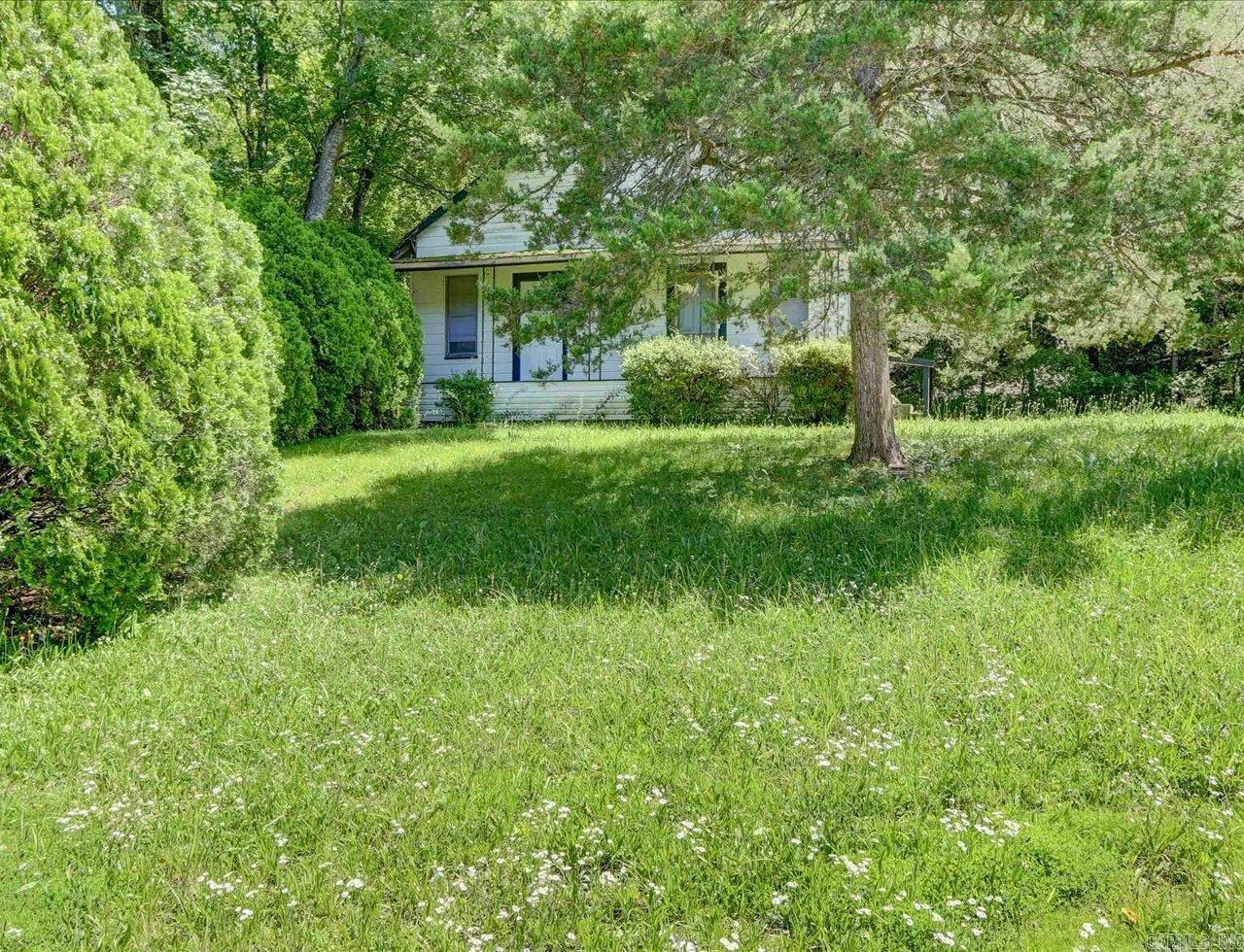 Charming One-Story Home on .24 Acres with Modern Updates and Private Wooded Views Welcome to this delightful one-story home, updated in 1990, nestled on a .24-acre lot with a concrete parking pad. Enjoy the tranquility and privacy provided by the wooded area that backs up to the property. Key Features: Inviting County Porch: Step onto the wide county porch, perfect for relaxing and enjoying the peaceful surroundings. Spacious Living Areas: The home features a welcoming Living Room that flows seamlessly into a Kitchen/Dining Combination, creating an open and airy feel. Two Oversized Bedrooms: Each bedroom boasts two closets, offering ample storage space. Full Bathroom: The bathroom includes a tub/shower combination for your convenience. Laundry Room: A dedicated Laundry Room adds to the home's functionality. Kitchen Highlights: The well-appointed kitchen comes with plenty of storage, a free-standing stove, dishwasher, and refrigerator, making meal preparation a breeze. Additional Information: The home is positioned high on the lot, ensuring plenty of privacy. Priced to sell fast, this home offers exceptional value for its size and features. Owner financing is preferred.